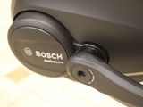 a close up of a black headphone on a stand