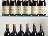 several bottles of wine are lined up on a glass shelf