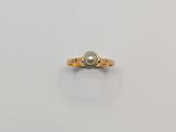 an image of a gold ring with a pearl in it