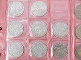 a pink box filled with lots of different types of coins
