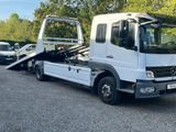 a white truck with a flat bed parked in a parking lot