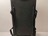 a black piece of luggage that is sitting on a table