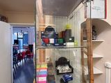 a glass case with various items in it in a room