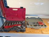 two tools in a tool box on a table