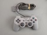 a video game controller and a charger on a table