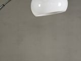 a white floor lamp with a chrome base and a white glass shade