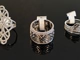 three different types of diamond rings on a black surface