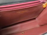 a black and pink purse that is open on the table