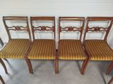 four chairs with striped upholstered seats in a room
