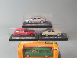 four different models of cars in a display case