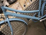 a blue bicycle parked next to a pile of boxes