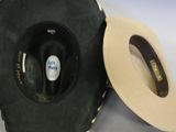 a black and white hat and a black and white hat on a white table