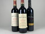 trois bouteilles de vin sont alignées sur une table