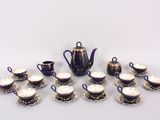 many cups and saucers and a teapot on the table