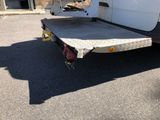 a white truck with a flat bed parked in a parking lot