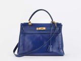 a blue leather handbag on a white background