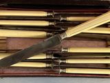 a box with a knife and a set of knives in it