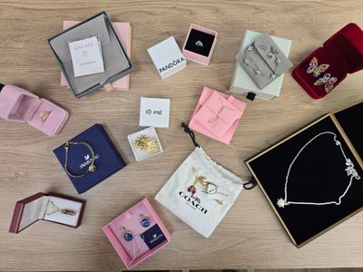 a lot of jewelry sitting on a table next to each other