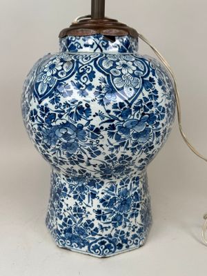 a blue and white lamp that is on a table