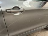 a close up of a car door handle with a sticker on it