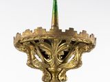 an image of a gold candle holder with a green top