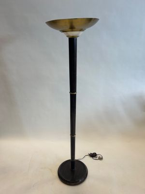 a black and gold floor lamp with a metal base