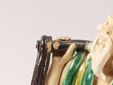 a figurine of an old man with a cane