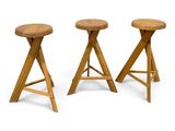 a set of three stools with wooden legs on a white background