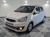 a picture of a small white car in a showroom