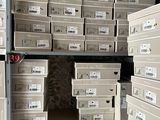 many boxes that are stacked on a shelf in a room