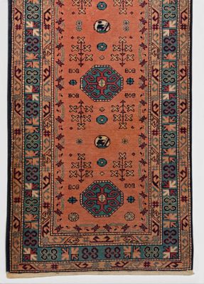 an orange and blue rug with a medallion design on it