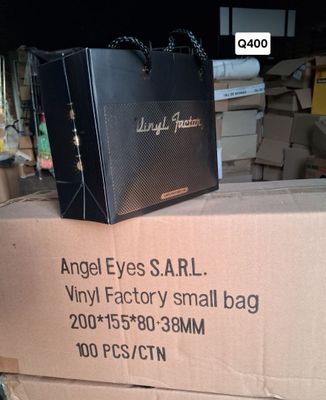 a black bag sitting on top of a cardboard box
