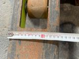 a measuring tape on a piece of wood next to a piece of wood