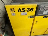 a yellow machine that is sitting in a garage