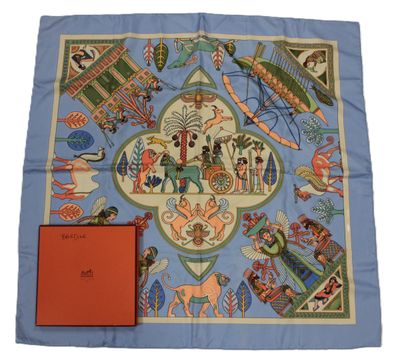 a blue scarf with a picture of people and animals on it