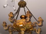a gold chandelier hanging from the ceiling in a room