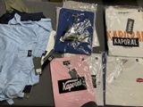 a lot of t - shirts that are on a table