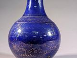 a blue vase sitting on a table with a white background