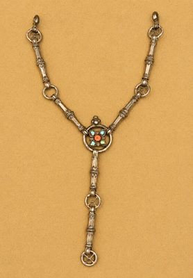 a silver necklace with a turquoise stone in the center