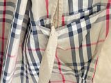 a teddy bear that is sitting in the pocket of a shirt
