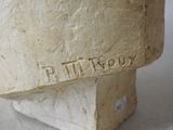a stone statue of a man with a name on it