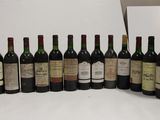 several bottles of wine are lined up on a white surface