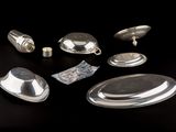 a lot of silver objects sitting on a black surface