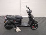 a scooter that is parked on a checkered floor