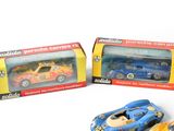 three toy cars sitting next to each other on a table