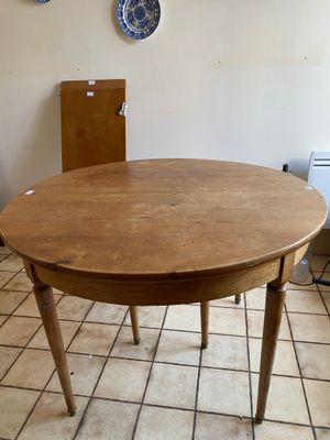 a round table with a wooden top in a kitchen