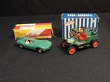 two toy cars that are sitting next to each other