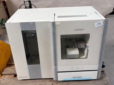 a white machine that is sitting on a pallet