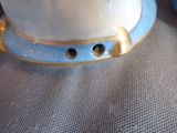a close up of a blue and white vase on a table