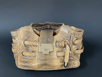 an image of a beige purse on a black background